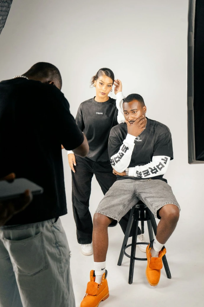 Photographer directs models during studio photoshoot